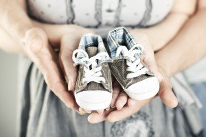 Couple with baby shoes