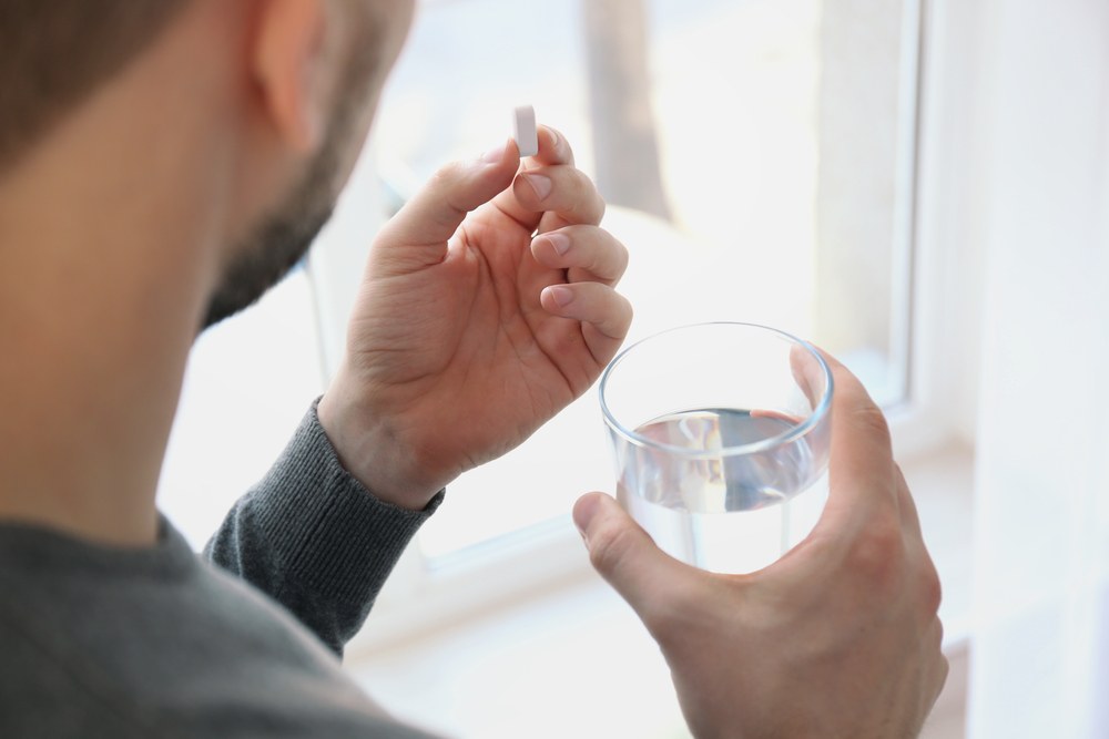 man taking ibuprofen