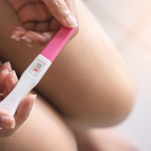 hands holding a negative pregnancy test