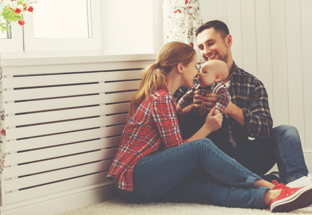 A couple with a baby in their arms