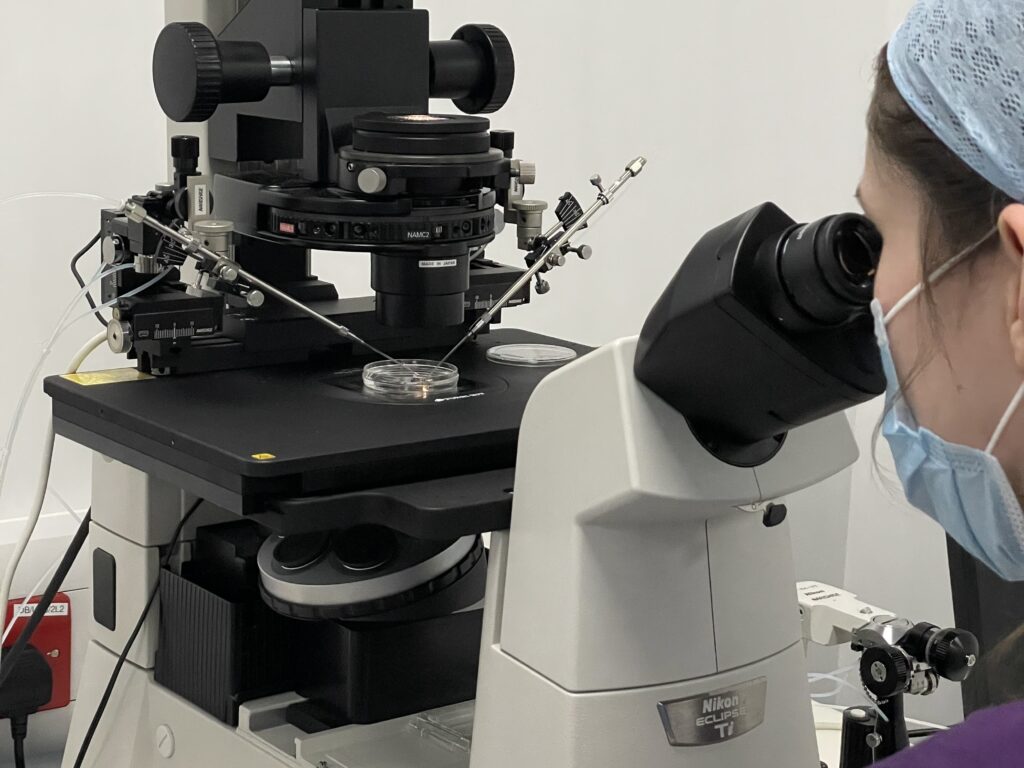 lady looking through a microscope