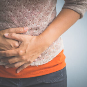 Woman holding her abdomen