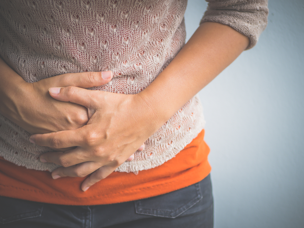 Woman holding her abdomen